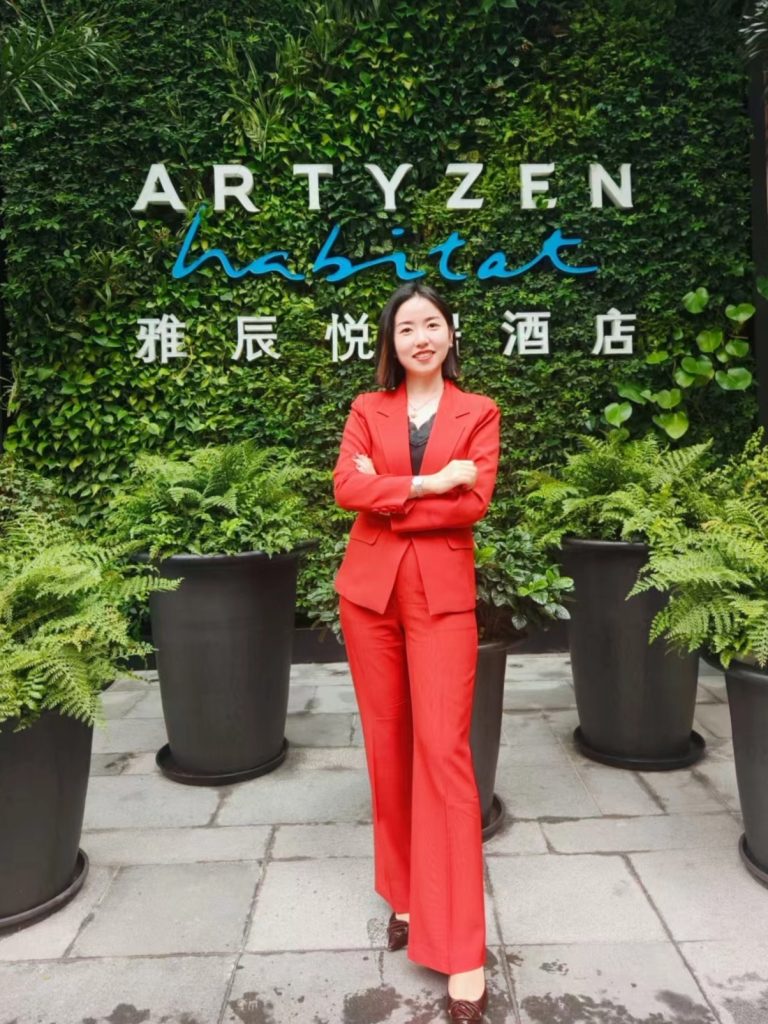 Amber Zhao, posing for a portrait in front of Artyzen Habitat Green Wall at the interview